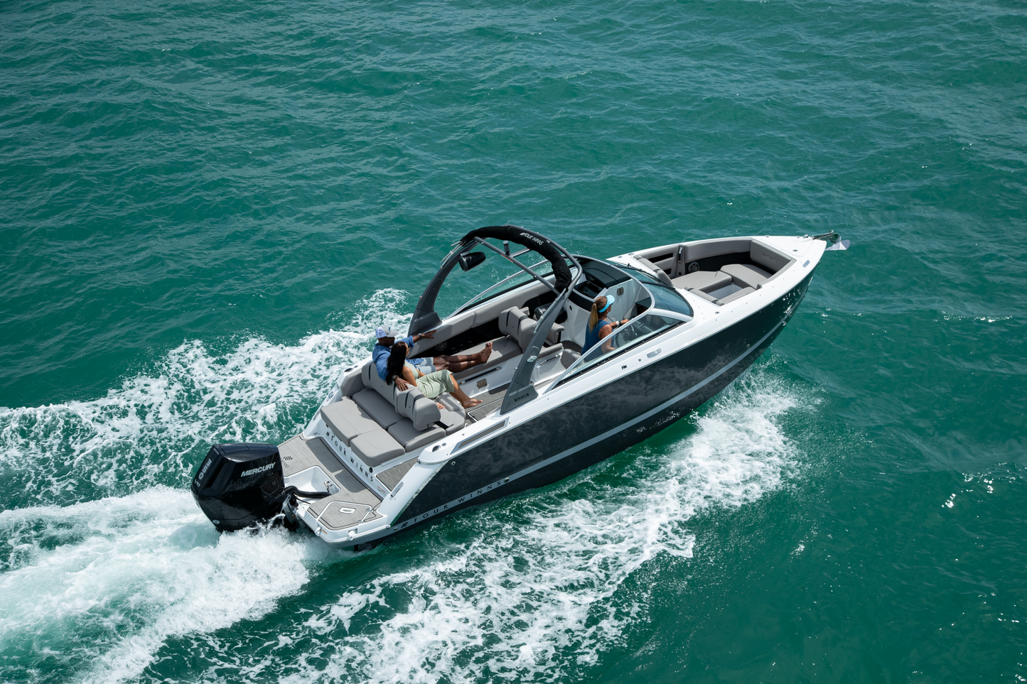 Four Winns H6 on a body of water with people on board available at Lark Marine, Northern Michigan