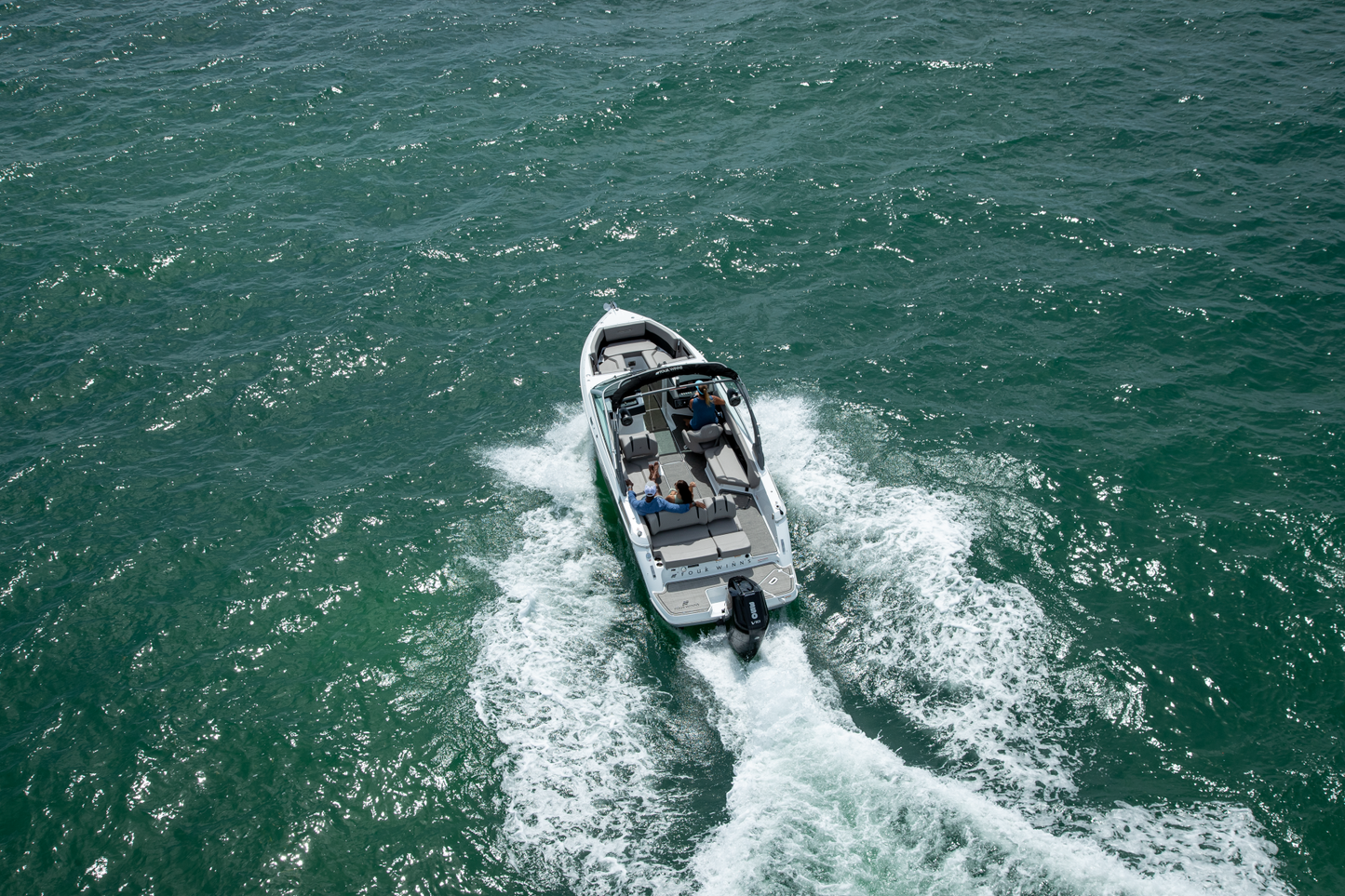 Four Winns H6 body of water with people on board available at Lark Marine, Northern Michigan