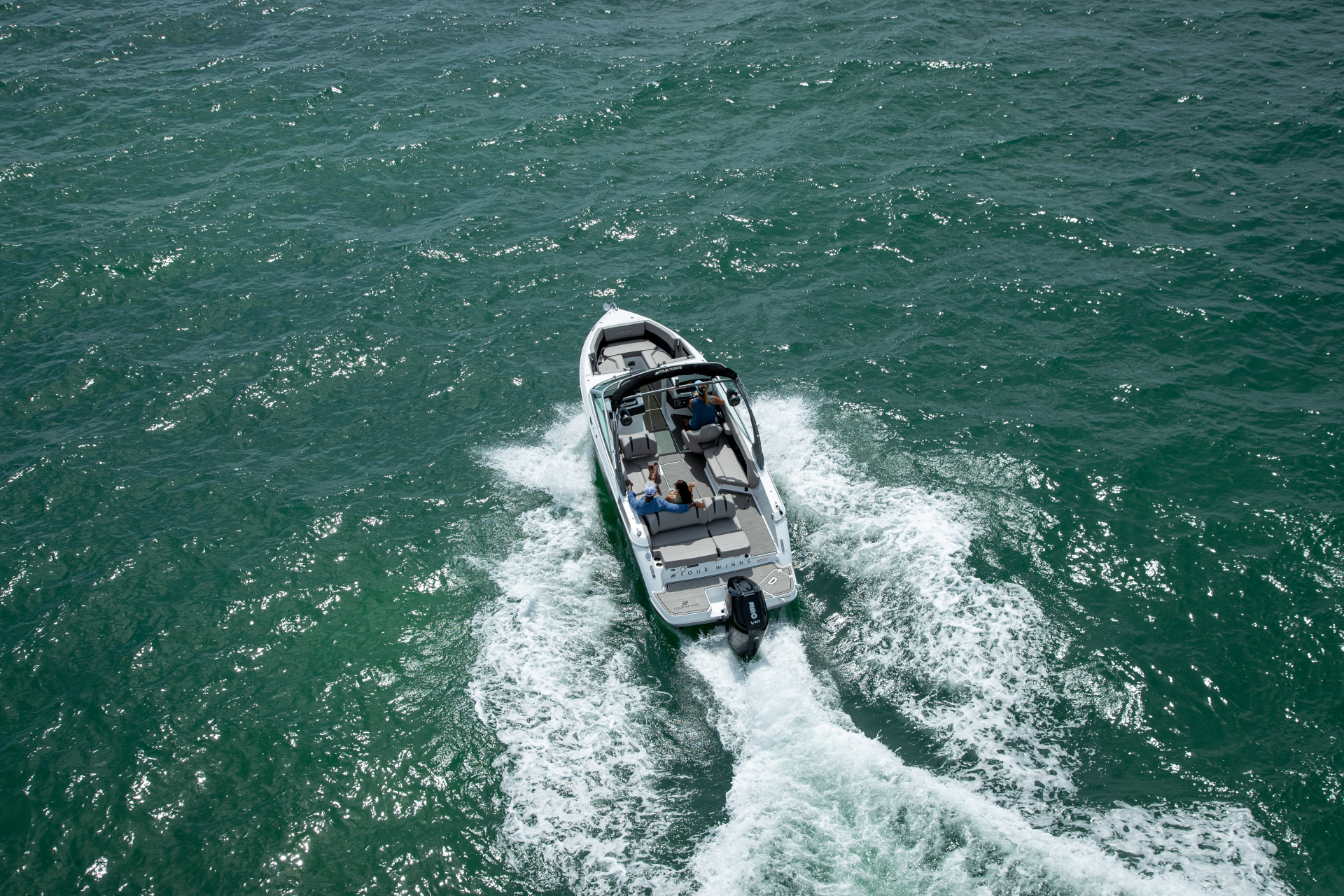 Four Winns H6 body of water with people on board available at Lark Marine, Northern Michigan